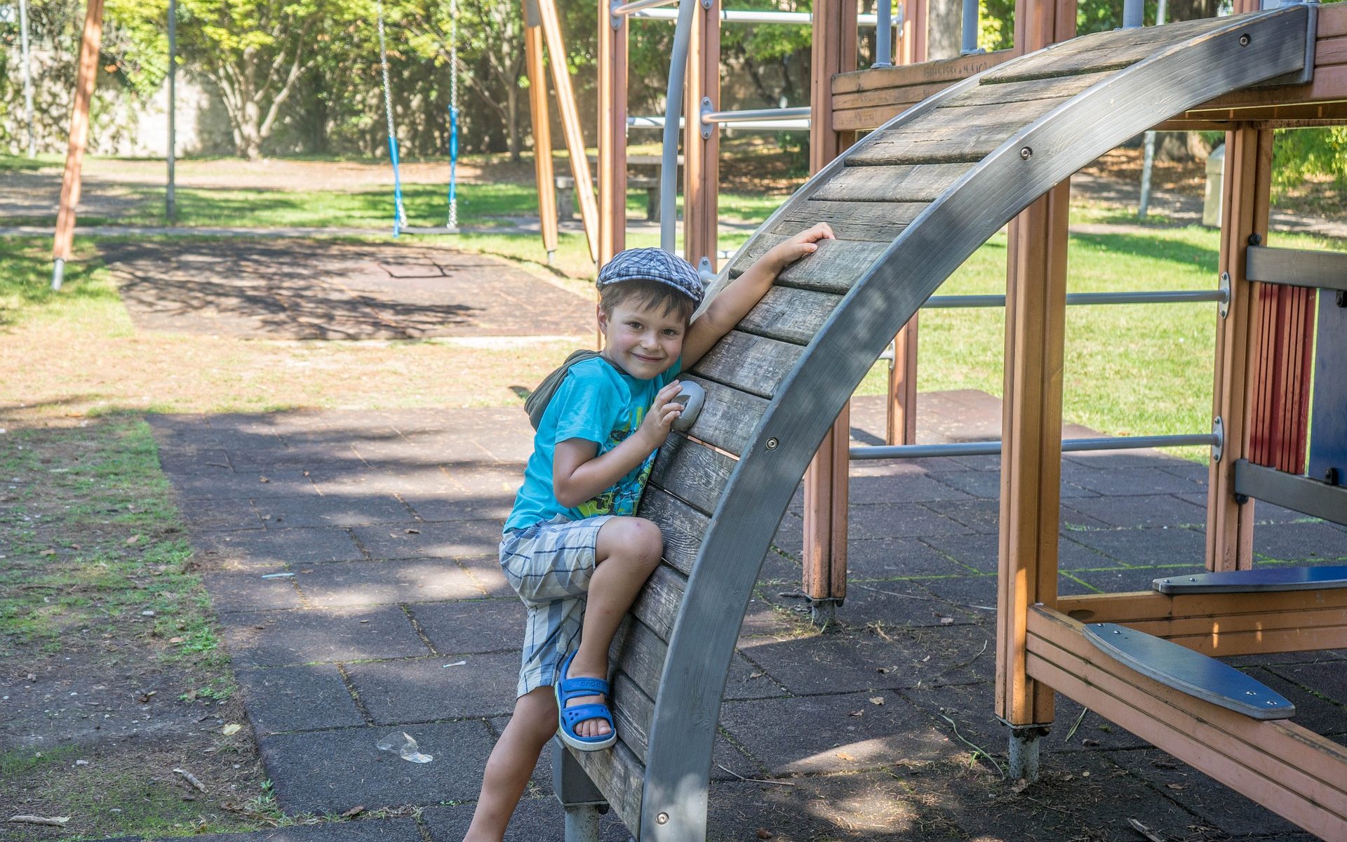 Young boy climbs on a playground.